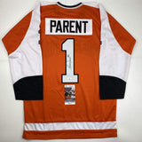 Camiseta de hockey naranja de Filadelfia autografiada/firmada por Bernie Parent (JSA COA)