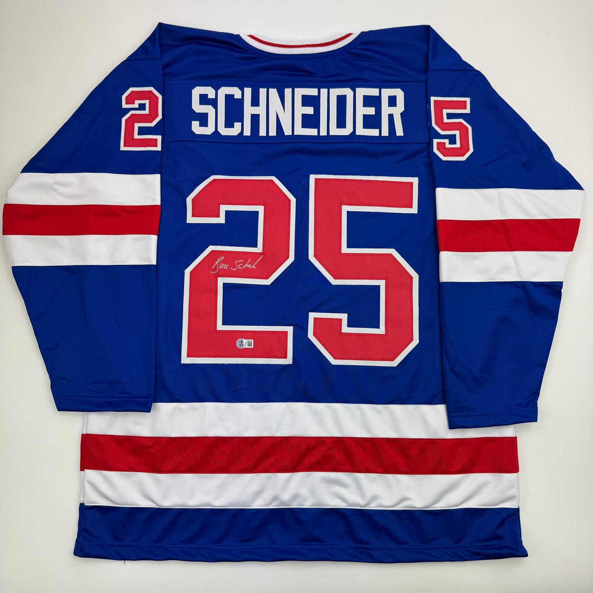 Camiseta de hockey azul autografiada/firmada de Buzz Schneider del equipo estadounidense Miracle On Ice de los Juegos Olímpicos de 1980, Beckett BAS COA