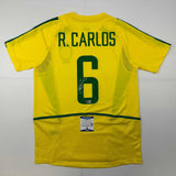 Camiseta de fútbol amarilla de Brasil autografiada/firmada de Roberto Carlos Beckett BAS COA