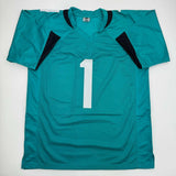 Camiseta de fútbol americano autografiada/firmada de Travis Etienne Jr. Jacksonville Teal Beckett BAS COA