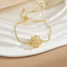 Pulsera sencilla de cobre puro chapada en oro con flores giratorias que conserva el color